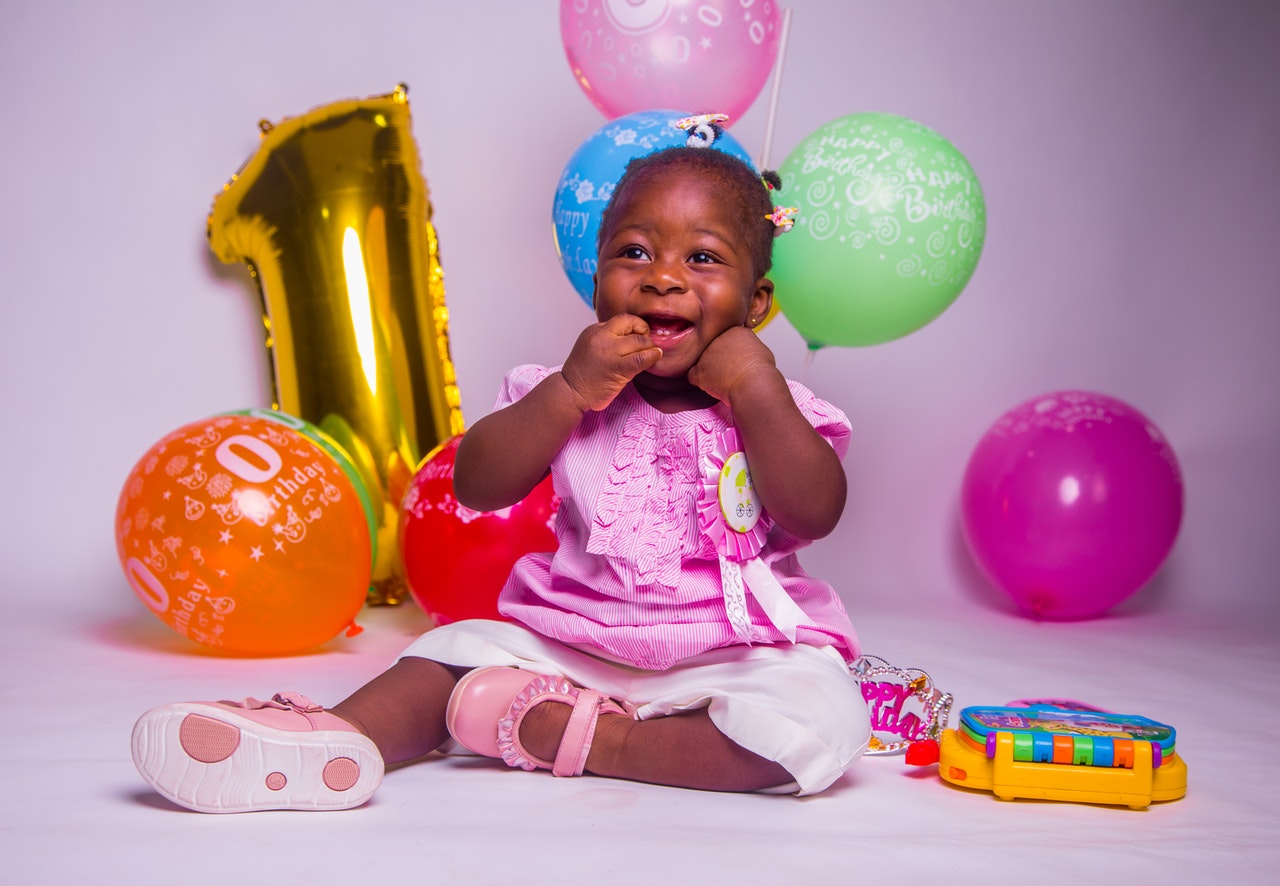 girl sitting on floor with balloons